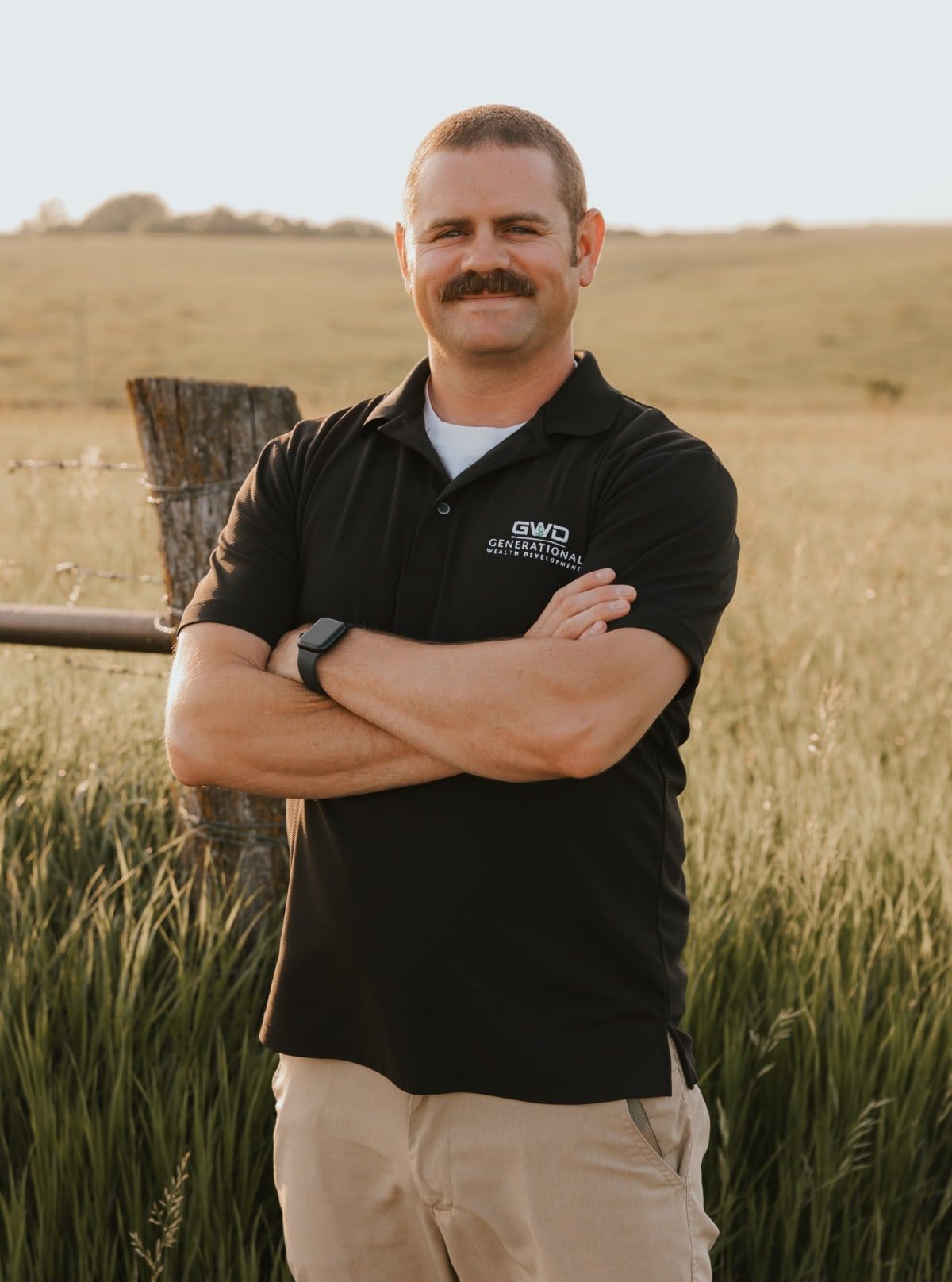Phillip Durbin, a middle-aged man with a mustache standing in front of a field.